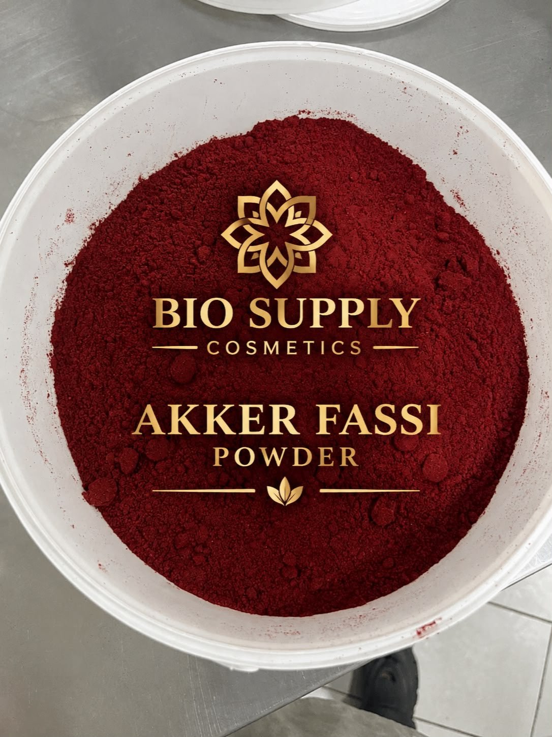 A deep red powder in a white bowl labeled Aker Fassi Powder