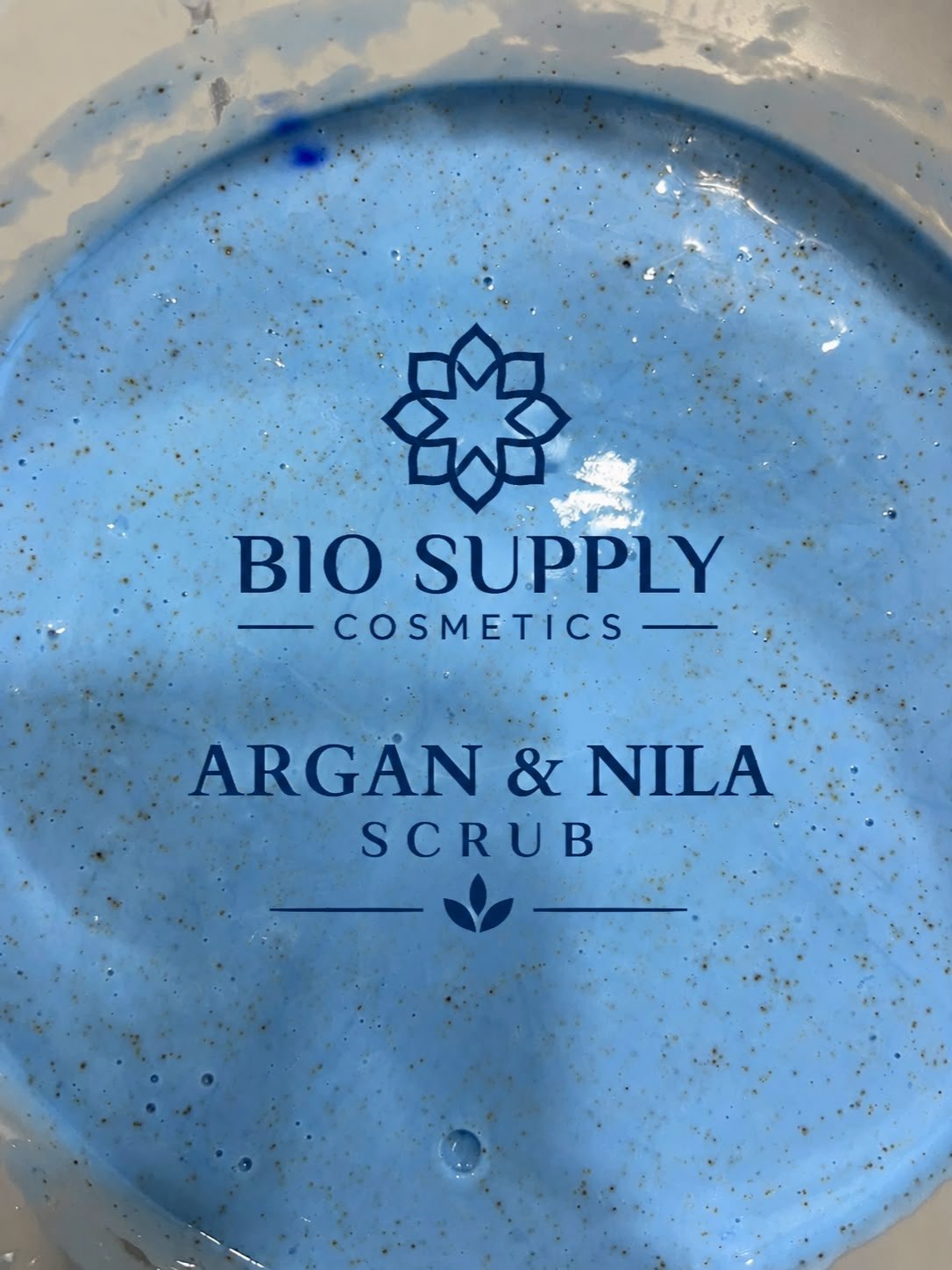 Blue cosmetic product labeled Argan and Nila Scrub